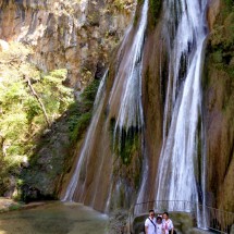 Chinese family on the waterfall Cascada Cola de Caballo